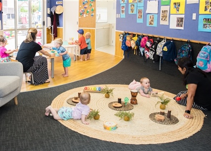 teacher and Children on mat at  Whangaparaoa Childcare