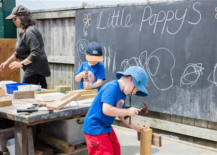 boys learning to nail wood at   Little Poppys Preschool